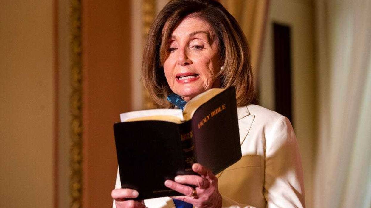 House Speaker Nancy Pelosi of Calif., reads from the Bible, as she reacts to President Donald Trump during a news conference at the U.S. Capitol in Washington, Tuesday, June 2, 2020.