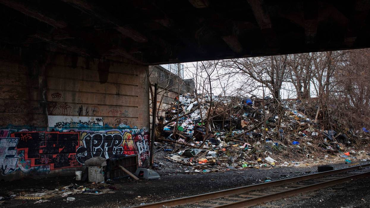 Household trash and graffiti are seen under a bridge near in Kensington, Philadelphia.