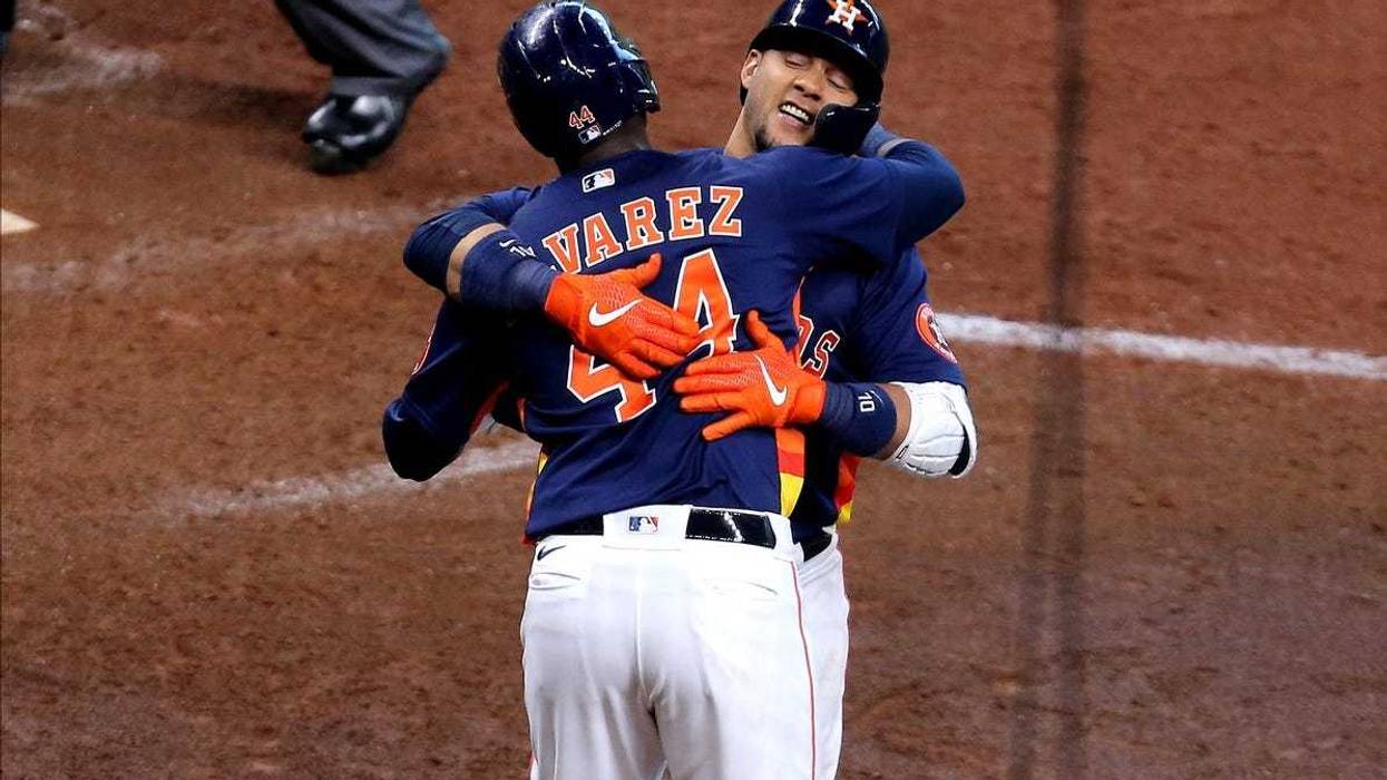Houston Astros first baseman Yuli Gurriel (10, right) is congratulated by Houston Astros left fielder Yordan Alvarez (44, left) after hitting a two-run home run against the Los Angeles Angels during the seventh inning at Minute Maid Park.
