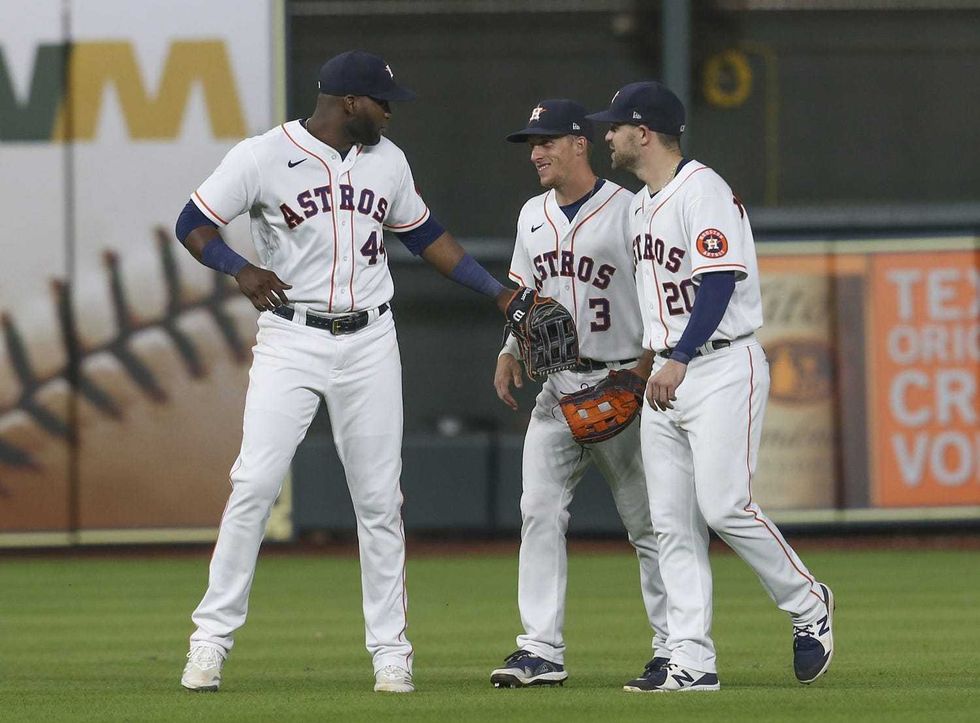 Houston Astros left fielder Yordan Alvarez (44) center fielder Myles Straw (3) and right fielder Chas McCormick (20) celebrate defeating the Texas Rangers at Minute Maid Park.