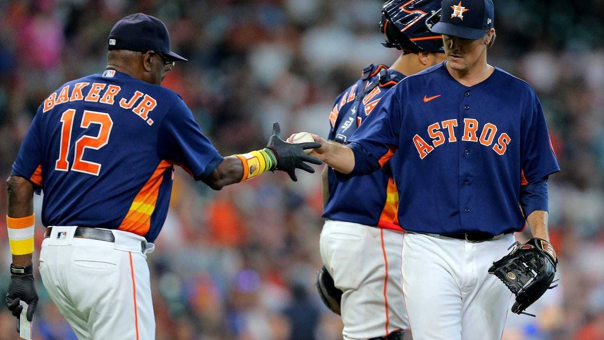 Houston Astros manager Dusty Baker (12) takes the ball from Houston Astros starting pitcher Zack Greinke (21) after reliving him from the game against the Texas Rangers during the seventh inning at Minute Maid Park.