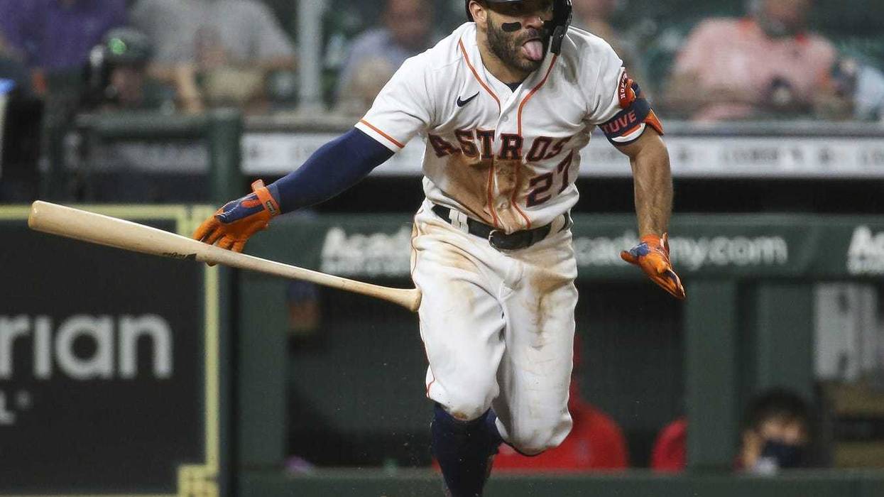 Houston Astros second baseman Jose Altuve (27) bunts for a single during the fourth inning against the Los Angeles Angels at Minute Maid Park.