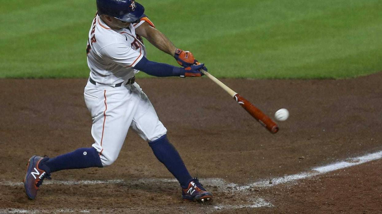 Houston Astros second baseman Jose Altuve (27) hits a two run RBI against the Seattle Mariners in the fourth inning at Minute Maid Park.
