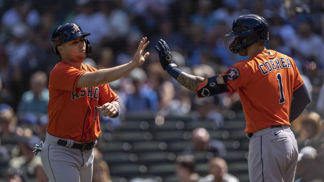Houston Astros third baseman Aledmys Diaz (16) is congratulated by shortstop Carlos Correa (1) after scoring a run on hit by first baseman Yuli Gurriel (10) during the sixth inning.