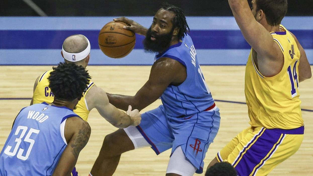 Houston Rockets guard James Harden (middle) dribbles the ball against the Los Angeles Lakers during the third quarter at Toyota Center.