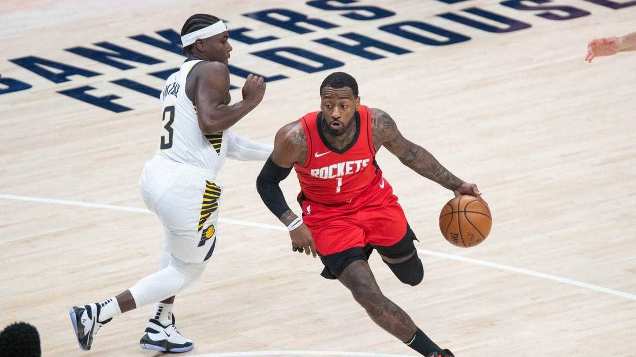Houston Rockets guard John Wall (1) dribbles the ball while Indiana Pacers guard Aaron Holiday (3) defends in the third quarter at Bankers Life Fieldhouse.