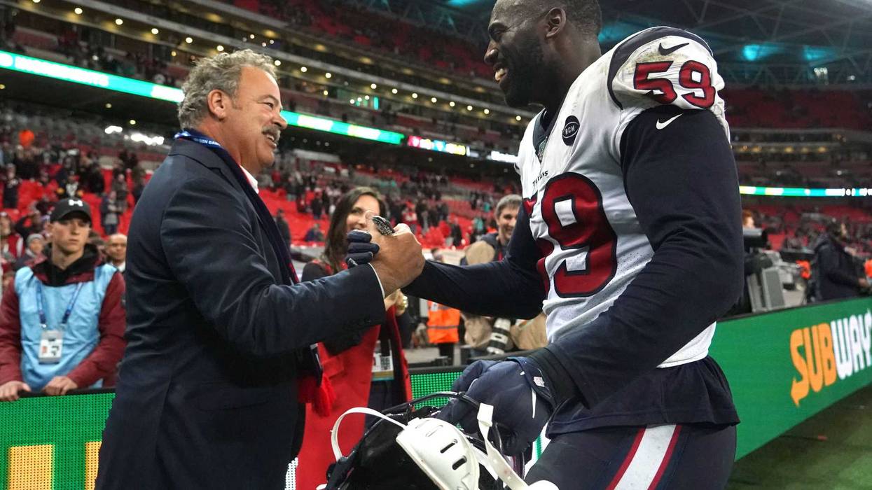 Houston Texans chief executive officer D. Cal McNair (left) shakes hands with outside linebacker Whitney Mercilus (59) after an NFL International Series game against the Jacksonville Jaguars.
