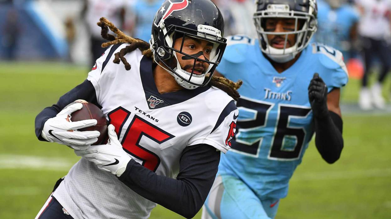 Houston Texans wide receiver Will Fuller (15) catches a pass past coverage fro Tennessee Titans cornerback Logan Ryan (26) during the second half at Nissan Stadium.