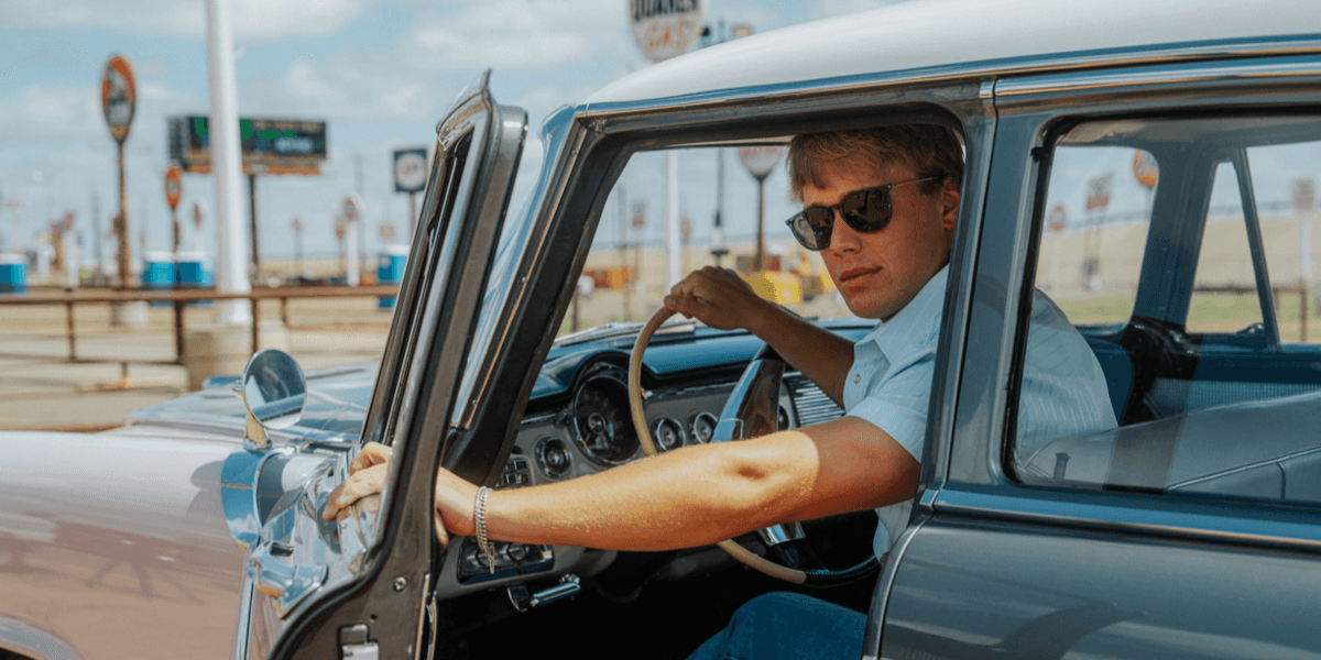 Hudson Westbrook driving a vintage car