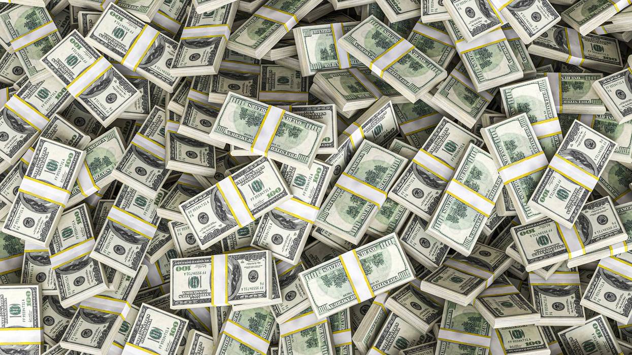 Huge pile of one hundred dollar bills filling the frame