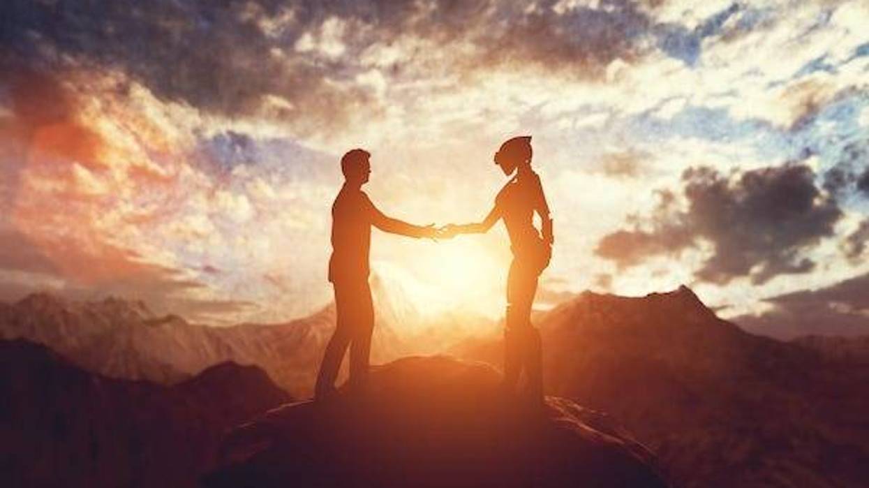 Human and alien shaking hands