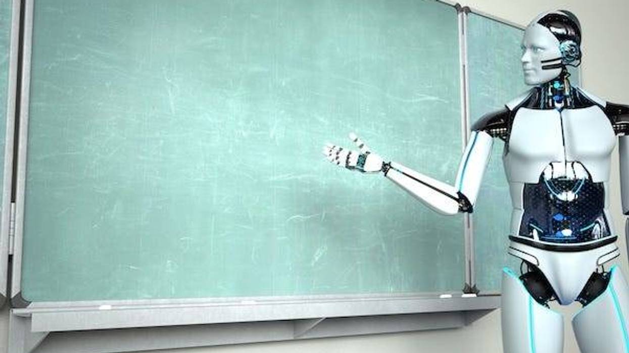 Humanoid robot teacher standing in front of a chalkboard