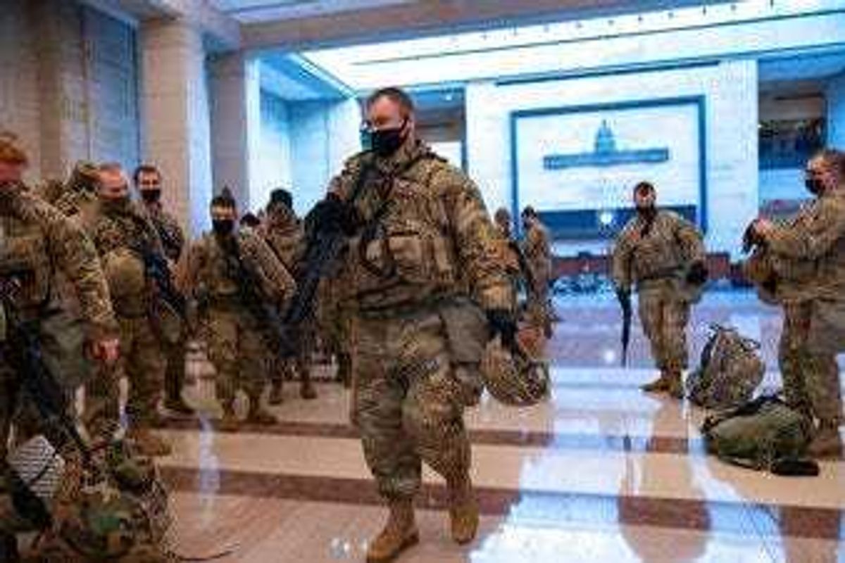 Hundreds of National Guard troops hold inside the Capitol Visitor's Center to reinforce security at the Capitol in Washington, Wednesday, Jan. 13, 2021. (AP Photo/J. Scott Applewhite)