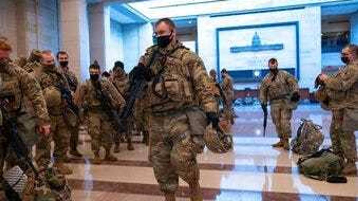Hundreds of National Guard troops hold inside the Capitol Visitor's Center to reinforce security at the Capitol in Washington, Wednesday, Jan. 13, 2021. (AP Photo/J. Scott Applewhite)