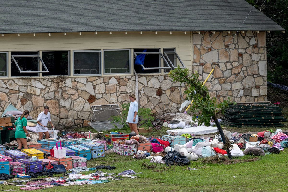 HUNT, TEXAS - JULY 07: People sift through children's belongings at Camp Mystic on July 07, 2025 in Hunt, Texas. Heavy rainfall caused severe flash flooding along the Guadalupe River in central Texas, leaving more than 90 people reported dead, including children attending the camp. (Photo by Brandon Bell/Getty Images)
