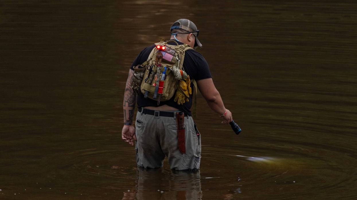 HUNT, TEXAS - JULY 6: A search and recovery worker shines his flashlight through through murky waters near Camp Mystic, looking for remains of victims on July 6, 2025 in Hunt, Texas. Heavy rainfall caused flooding along the Guadalupe River in central Texas with multiple fatalities reported. (Photo by Jim Vondruska/Getty Images)