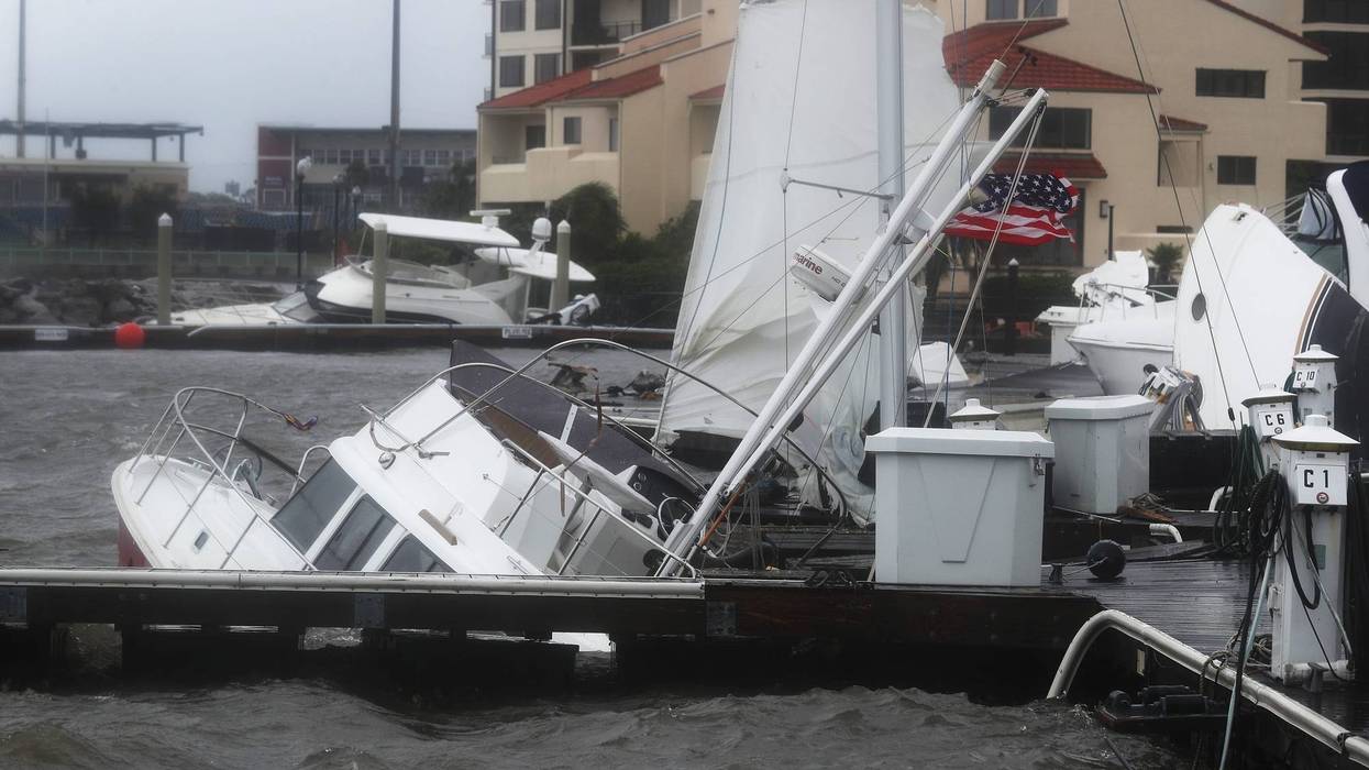 Hurricane sinks boats tied to pier in Pensacola