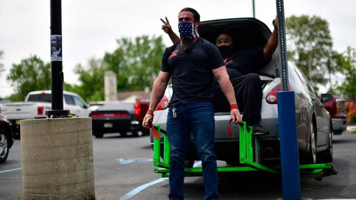 Ian Smith, co-owner of Atilis Gym lifts a car in the parking lot on May 20, 2020 in Bellmawr, New Jersey.
