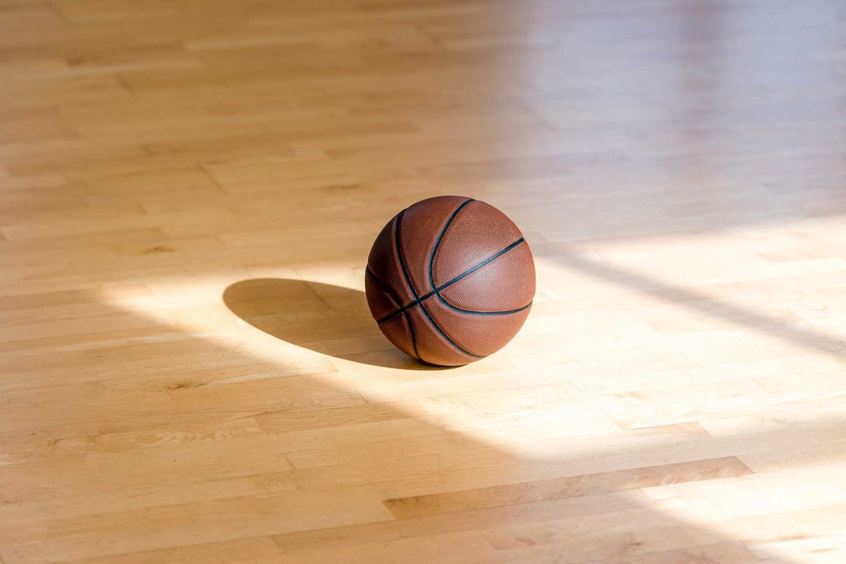 iBasketball court wooden floor with professional brown leather ball and shadows. Horizontal sport poster, greeting cards, headers, website