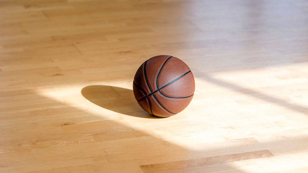 iBasketball court wooden floor with professional brown leather ball and shadows. Horizontal sport poster, greeting cards, headers, website