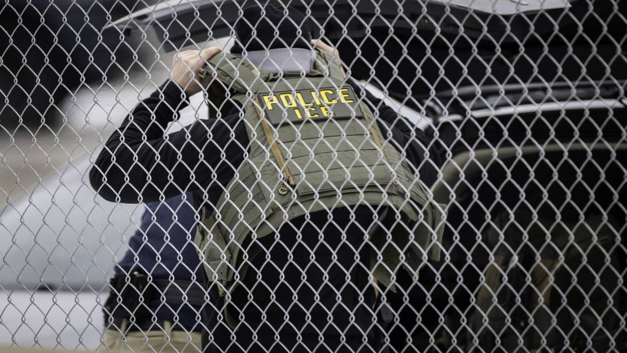 ICE agent putting on vest