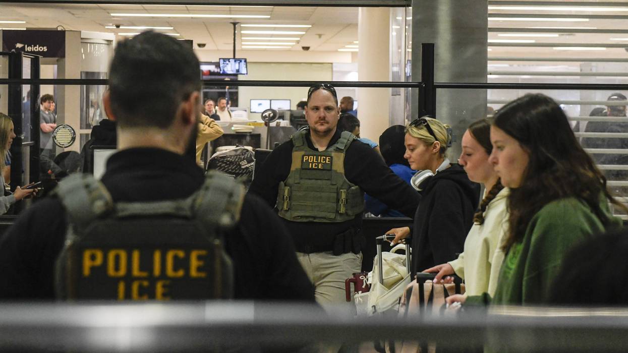 ICE agents stand beside a security screening line at a TSA Checkpoint at the Philadelphia International Airport on March 28, 2026 in Philadelphia, Pennsylvania.