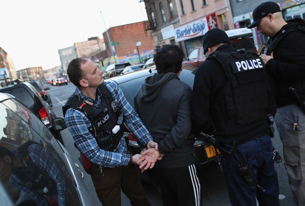 ICE agents take a man into custody in Bushwick, Brooklyn