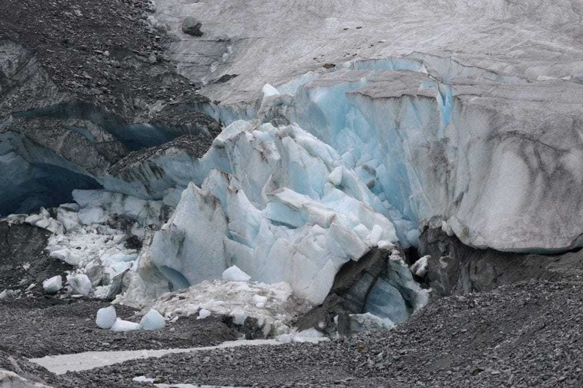 Ice breaks off the receding Findel glacier at a stream of the glacier's meltwater on June 22, 2022 near Zermatt, Switzerland. The Findel glacier, which descends from the Monta Rosa massif, once filled a wide ravine running over two kilometers below its current terminus. Matthias Huss, a glaciologist with ETH Zurich university and head of the Swiss glacier monitoring network, has been studying the Findel and reports that the glacier is losing mass at a rate significantly faster than average since 2011. This summer is likely to be especially brutal for Switzerland’s glaciers. Normally in mid-June glaciers, including the Findel, would still be covered in snow that protects them from the sun, though because very little snow fell this year, the glaciers are already exposed and melting rapidly under conditions that are more typical for late July or August. Huss and his colleagues are studying approximately 20 glaciers across Switzerland to observe the effects of global warming. All of the glaciers are melting, and he predicts that if we do not meet global climate goals Switzerland’s glaciers will be mostly gone by 2100. (Photo by Sean Gallup/Getty Images)