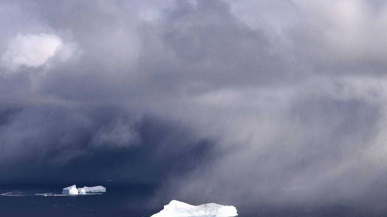 Icebergs and light snowfall are seen from NASA's Oceans Melting Greenland (OMG) research aircraft near the west coast on September 7, 2021 above Greenland. The NASA Oceans Melting Greenland (OMG) campaign is wrapping up a six-year mission studying the ocean and glaciers along Greenland’s 24,000 mile remote coastline with airborne and shipborne instruments- data which cannot be captured by satellite. Each summer, OMG releases around 250 ocean probes from a modified DC-3 aircraft into the ocean to monitor the temperature and salinity of Atlantic subsurface waters around Greenland. According to NASA, the goal of the mission is ‘to figure out how much of Greenland’s ice melt is caused by warming oceans.’ Greenland’s massive ice sheet holds enough water to raise sea levels by around 25 feet worldwide. (Photo by Mario Tama/Getty Images)