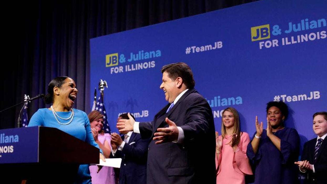 Illinois Democratic candidate for Governor J.B. Pritzker gesture towards his Lieutenant Governor pick Juliana Stratton for a hug during his primary election night victory speech on March 20, 2018 in Chicago, Illinois. Pritzker won the democratic primary against challengers Chris Kennedy and Daniel Bliss in the governor's race.
