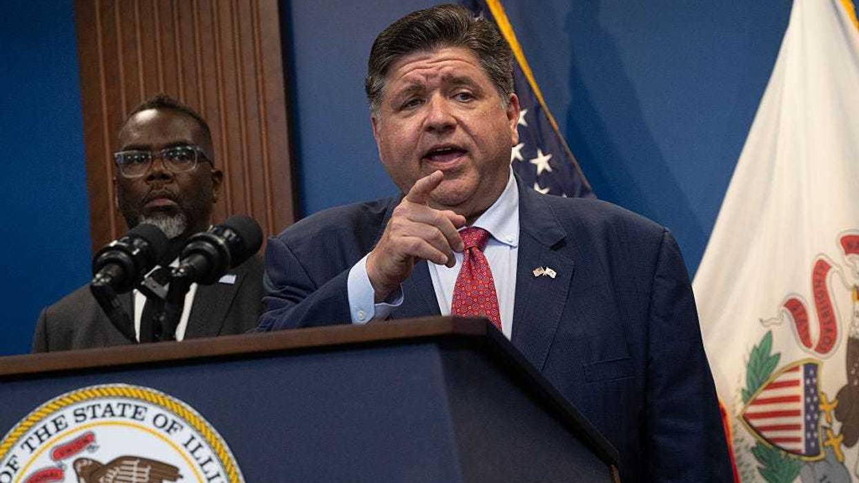 Illinois Governor J.B. Pritzker answers a question during a news conference as Chicago mayor Brandon Johnson looks on.