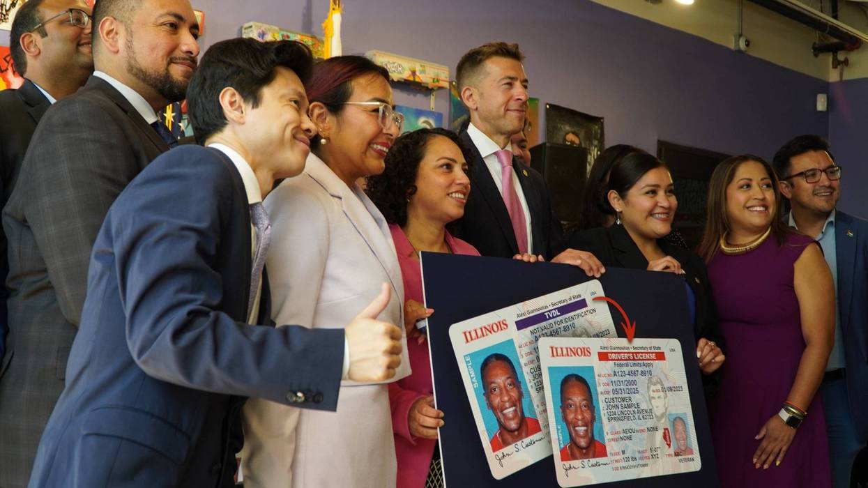 Illinois Secretary of State Alexi Giannoulias and several others pose for a photo on Monday after an announcement that undocumented immigrants in Chicago and Illinois will now be able to apply for a standard driver's license.