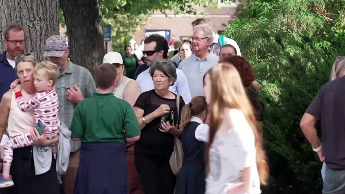 Mourners gather near Annunciation school and church while stories of recovery and heroism emerge
