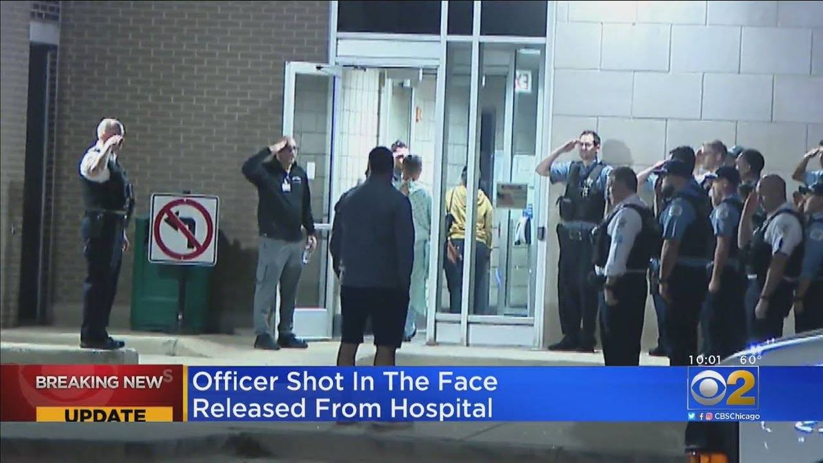 Chicago police officer released from hospital hours after being shot in the face, stops by police station in his hospital gown