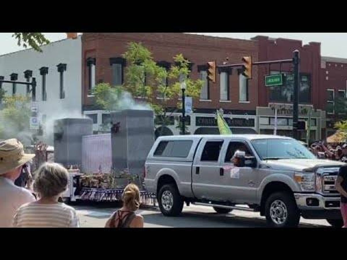 Parade float evoking smoking Twin Towers gets mixed response