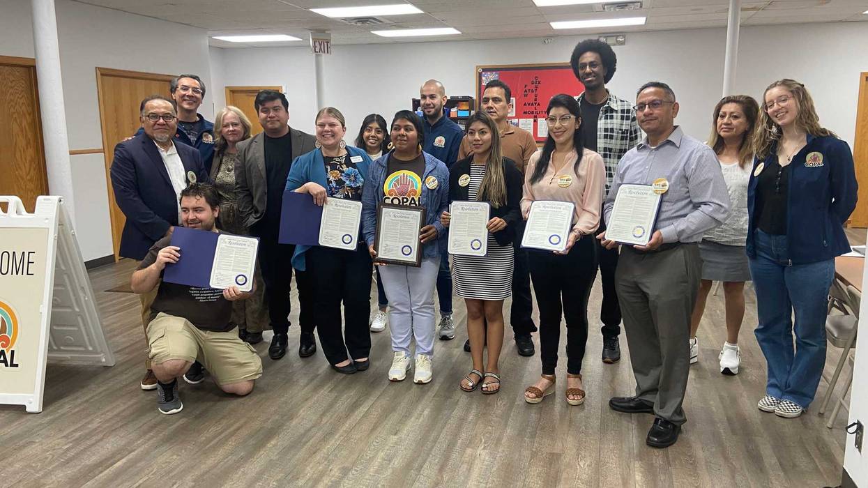Immigrants from Ecuador proudly show off the new resolution supporting temporary protection status as they flee the violence, political persecution and economic and social disasters in their country.