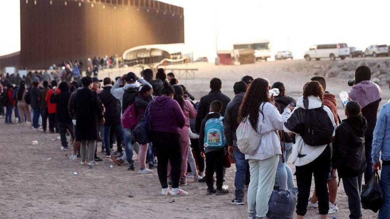 Immigrants seeking asylum in the United States wait in line to be processed by U.S. Border Patrol agents after crossing into Arizona from Mexico on May 11, 2023 in Yuma, Arizona. A surge of immigrants is expected with the end of the U.S. government's Covid-era Title 42 policy, which for the past three years has allowed for the quick expulsion of irregular migrants entering the country.