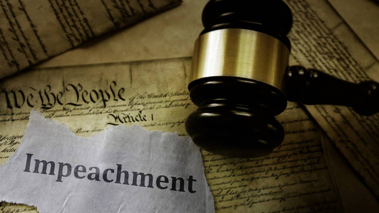 Impeachment message on pages of the US Constitution with legal gavel