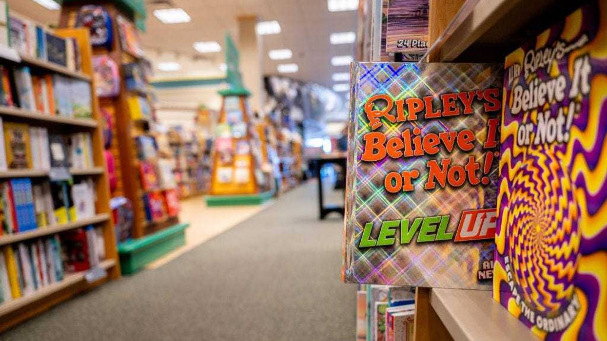In a photo illustration, a 'Ripley's Believe It or Not!' book is pulled out on a shelf at a Barnes & Noble store on January 11, 2024 in Austin, Texas. The book is among several being banned in a Florida school district. The Escambia county, Florida school district is facing a federal lawsuit after removing copies of dictionaries, encyclopedias and various other books containing "sexual conduct." The school district decision comes after officials ruled in accordance with a law signed by Florida Gov. Ron DeSantis, which restricts access to information containing sexual conduct in the Florida educational system. (Photo by Brandon Bell/Getty Images)
