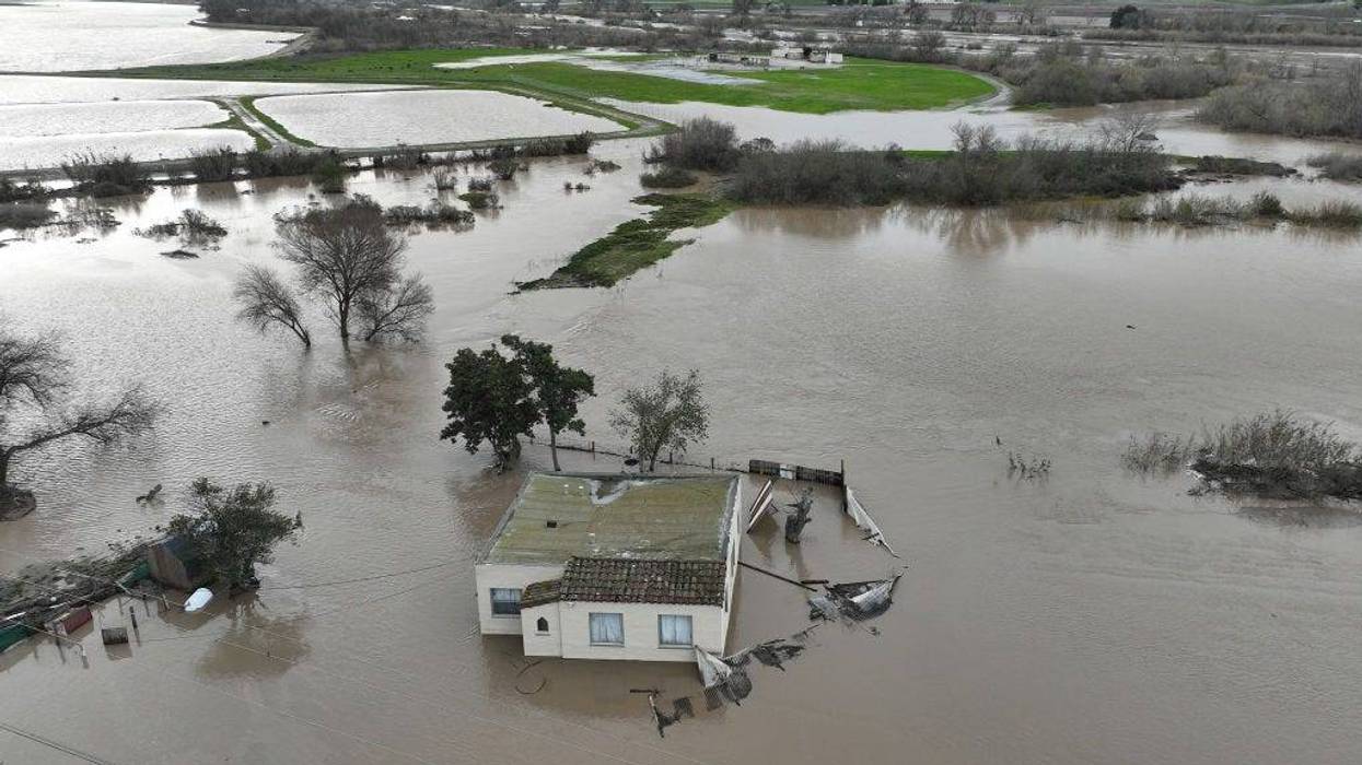 In an aerial view, a home is seen submerged in floodwater as the Salinas River begins to overflow its banks on January 13, 2023 in Salinas, California.