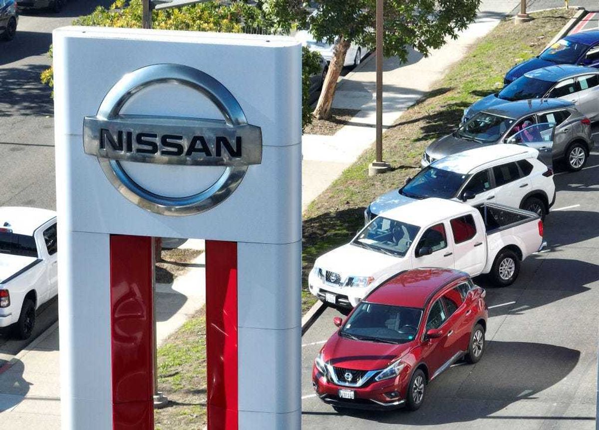 In an aerial view, a sign is posted in front of a Nissan dealership on February 09, 2023 in Richmond, California.