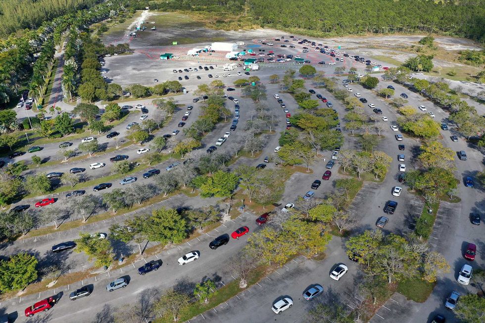In an aerial view, cars line up at a drive-thru COVID-19 testing site at the Zoo Miami site on December 29, 2021 in Miami, Florida