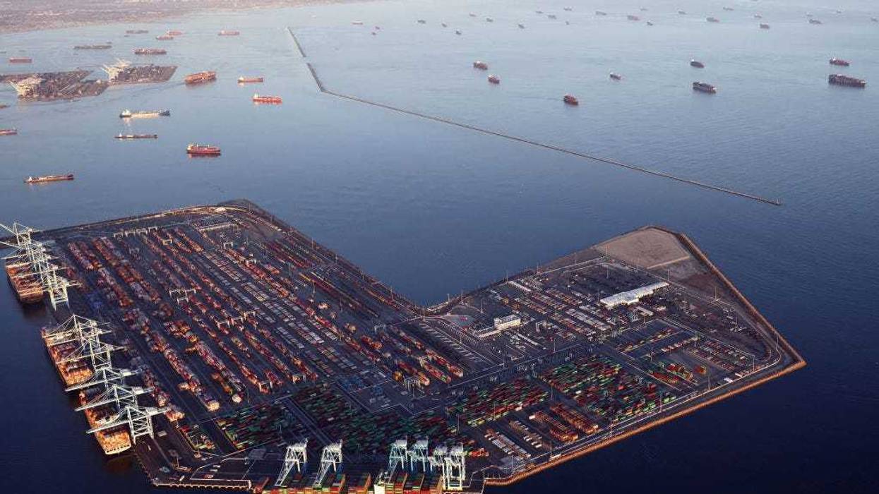 In an aerial view, container ships (Top R) are anchored by the ports of Long Beach and Los Angeles as they wait to offload on September 20, 2021 near Los Angeles, California. Amid a record-high demand for imported goods and a shortage of shipping containers and truckers, the twin ports are currently seeing unprecedented congestion. On September 17, there were a record total of 147 ships, 95 of which were container ships, in the twin ports, which move about 40 percent of all cargo containers entering the U.S. (Photo by Mario Tama/Getty Images)
