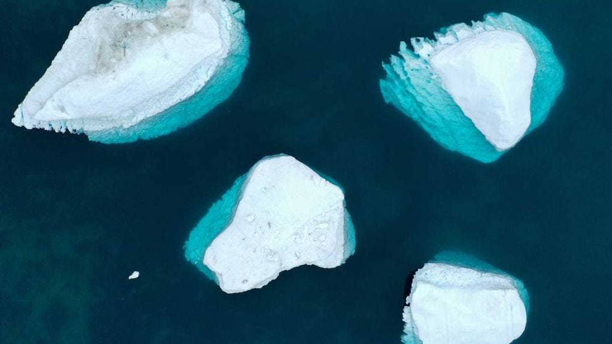 In an aerial view, icebergs which calved from the Sermeq Kujalleq glacier float in the Ilulissat Icefjord on September 04, 2021 in Ilulissat, Greenland. 2021 will mark one of the biggest ice melt years for Greenland in recorded history. Researchers from Denmark estimated that in July of this year enough ice melted on the Greenland Ice Sheet to cover the entire state of Florida with two inches of water. According to NASA, Greenland has melted 5 trillion tons of ice over approximately the past 15 years, enough to increase global sea level by nearly an inch. The observations come on the heels of the recent United Nations report on global warming which stated that accelerating climate change is driving an increase in extreme weather events. (Photo by Mario Tama/Getty Images)