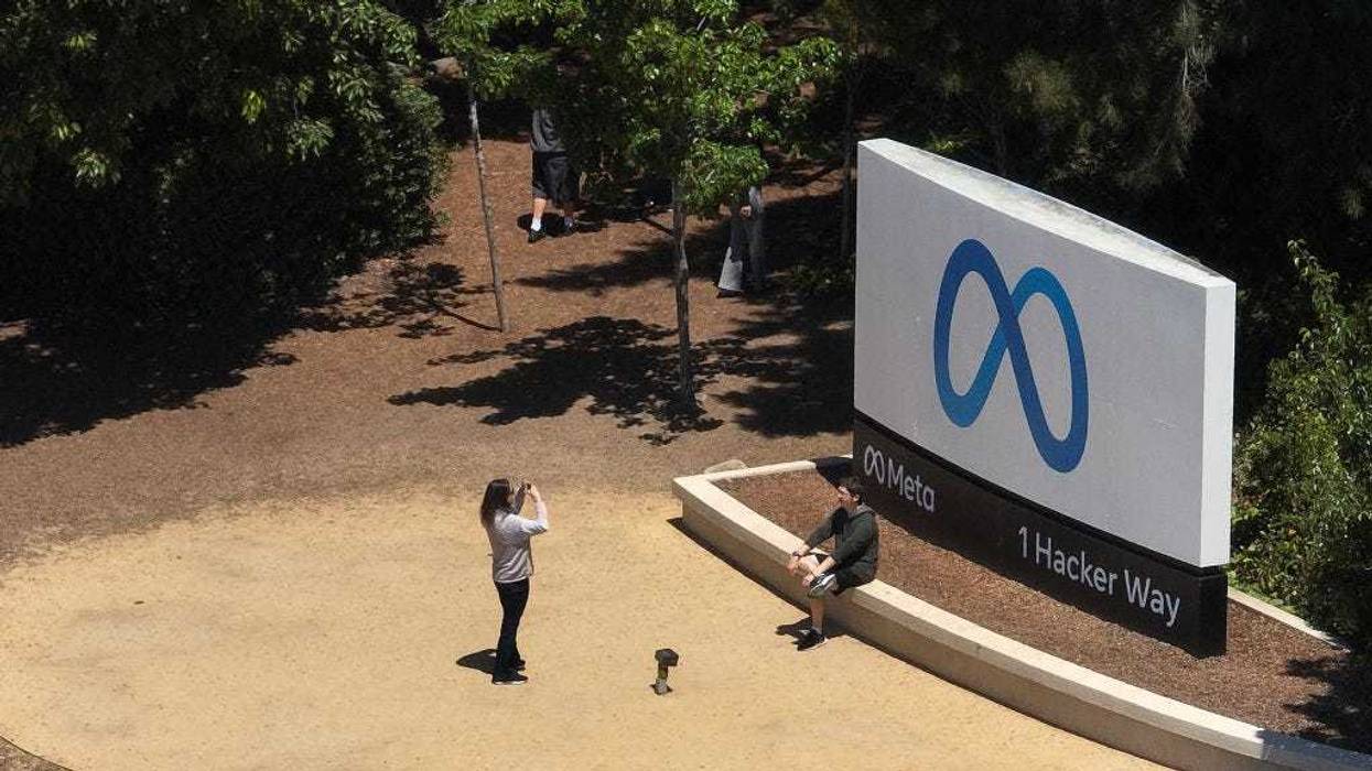 In an aerial view, people gather in front of a sign posted at Meta headquarters on July 07, 2023 in Menlo Park, California.