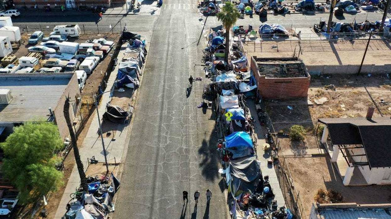 In an aerial view, people walk through a section of the 'The Zone', Phoenix's largest homeless encampment, amid the city's worst heat wave on record on July 26, 2023 in Phoenix, Arizona.