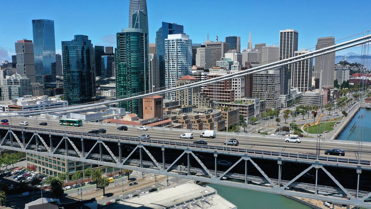 In an aerial view, traffic crosses the San Francisco-Oakland Bay Bridge on June 14, 2021 in San Francisco, California.