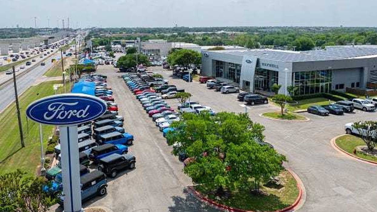 In an aerial view, vehicles are seen for sale on a lot at a dealership on April 18, 2025 in Austin, Texas.