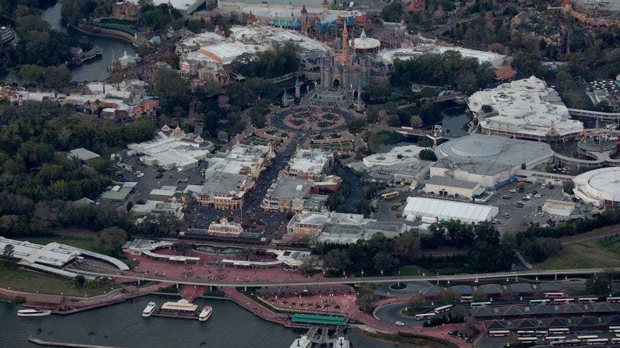In an aerial view, Walt Disney World's iconic Cinderella Castle sits on the grounds of the theme park on February 08, 2023 in Orlando, Florida. As Florida Gov. Ron DeSantis continues his push to punish Walt Disney Co. by taking control of the board of Disney's special taxing district, the company announced today a restructuring. As a result, Disney expects to cut costs by $5.5 billion and lay off roughly 7,000 employees, or about 4 percent of its global workforce. (Photo by Joe Raedle/Getty Images)
