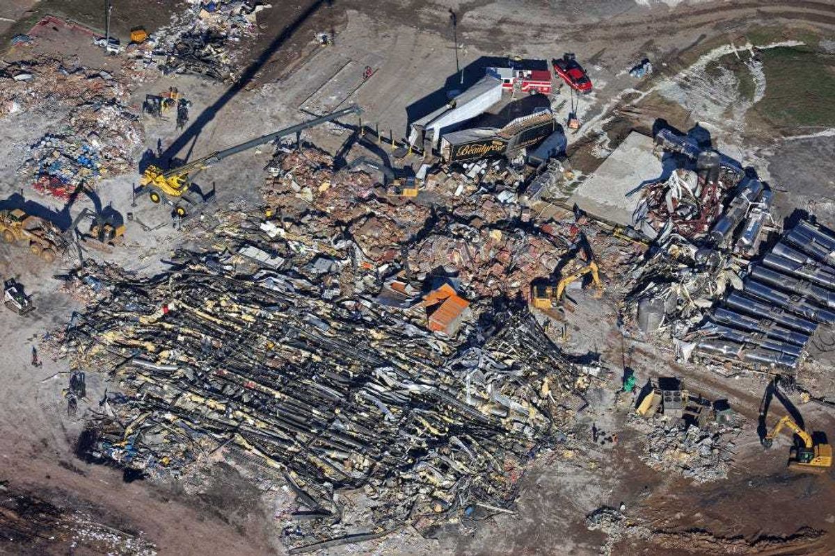 In this aerial view, crews clear the rubble at the Mayfield Consumer Products candle factory after it was destroyed by a tornado three days prior, on December 13, 2021 in Mayfield, Kentucky. Multiple tornadoes struck several Midwest states in the late evening on December 10, causing widespread destruction and multiple fatalities. (Photo by Scott Olson/Getty Images)